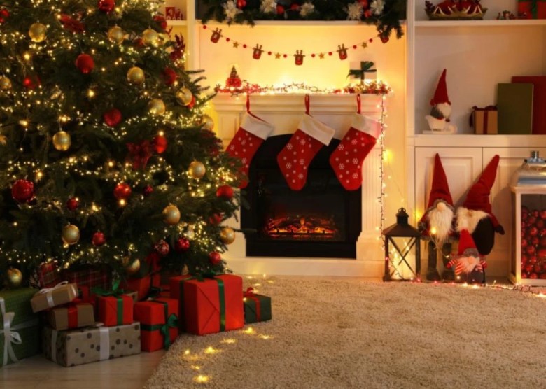 Tinsel, ribbon, and ornaments A Christmas tree with lights and presents in a decorated living room.